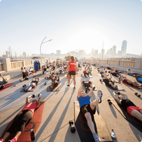 Multiple people exercising at a bridge